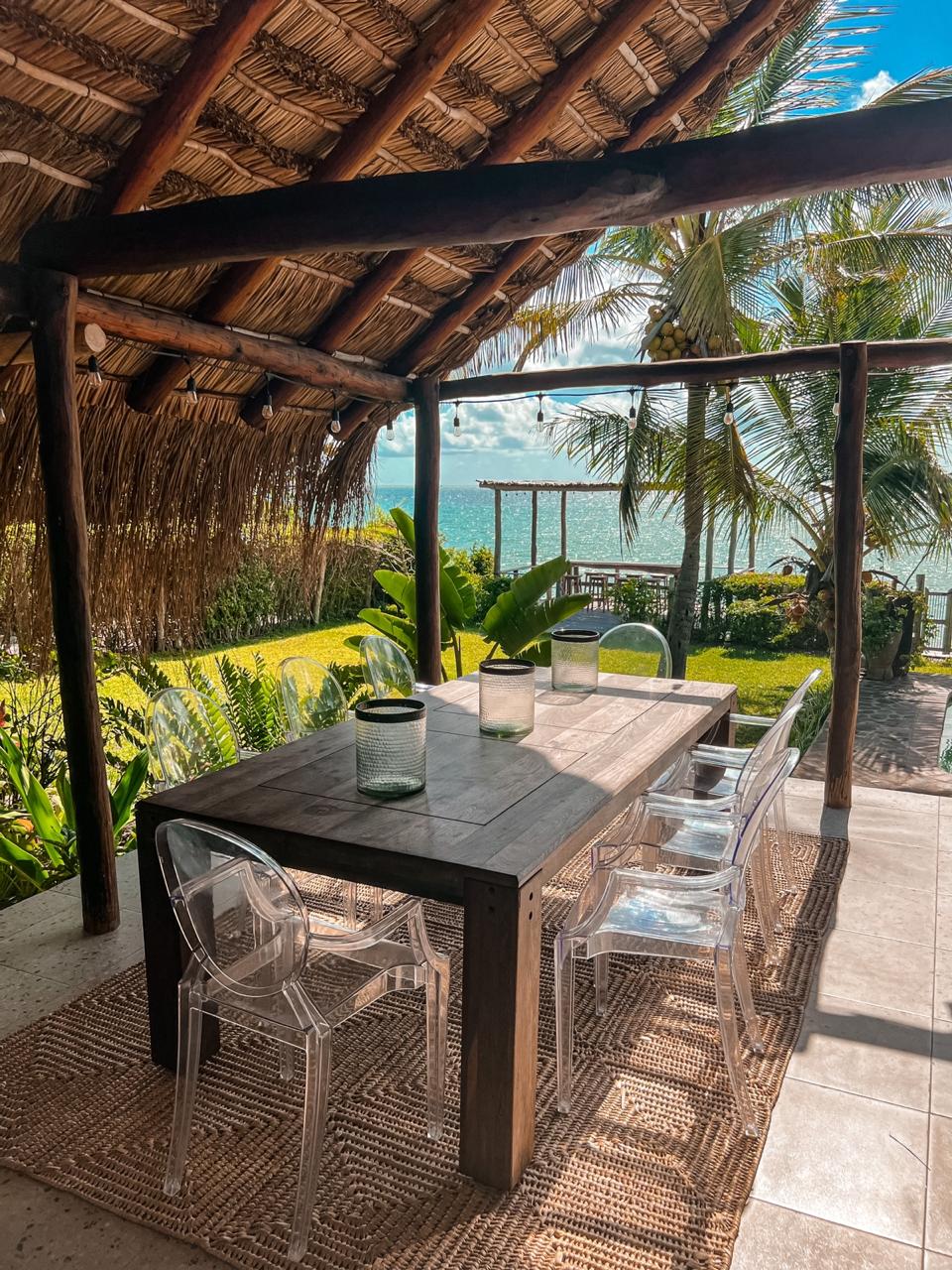 Thatched pergola outdoor dining with ocean view